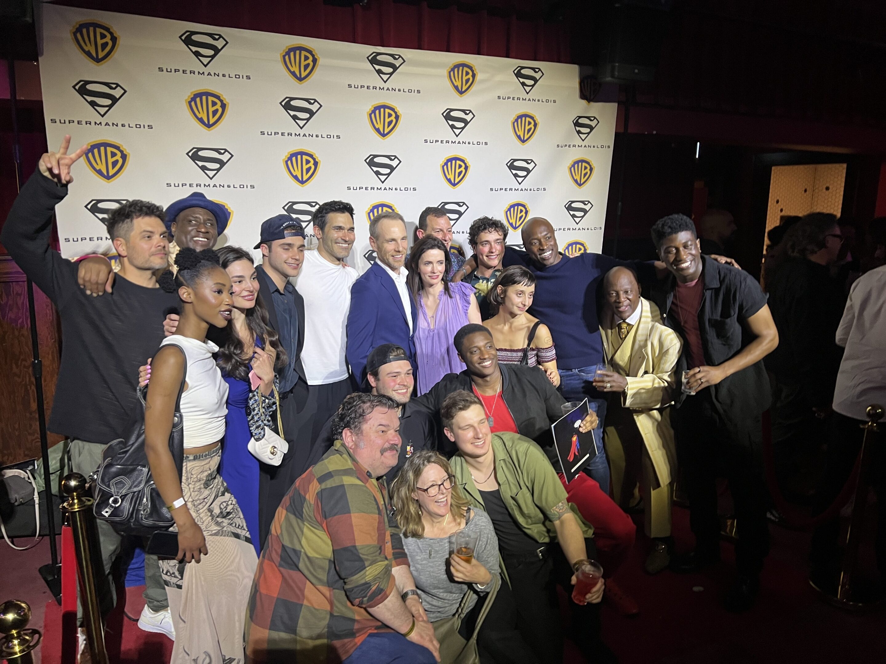 A group of people posing for a picture on the red carpet.