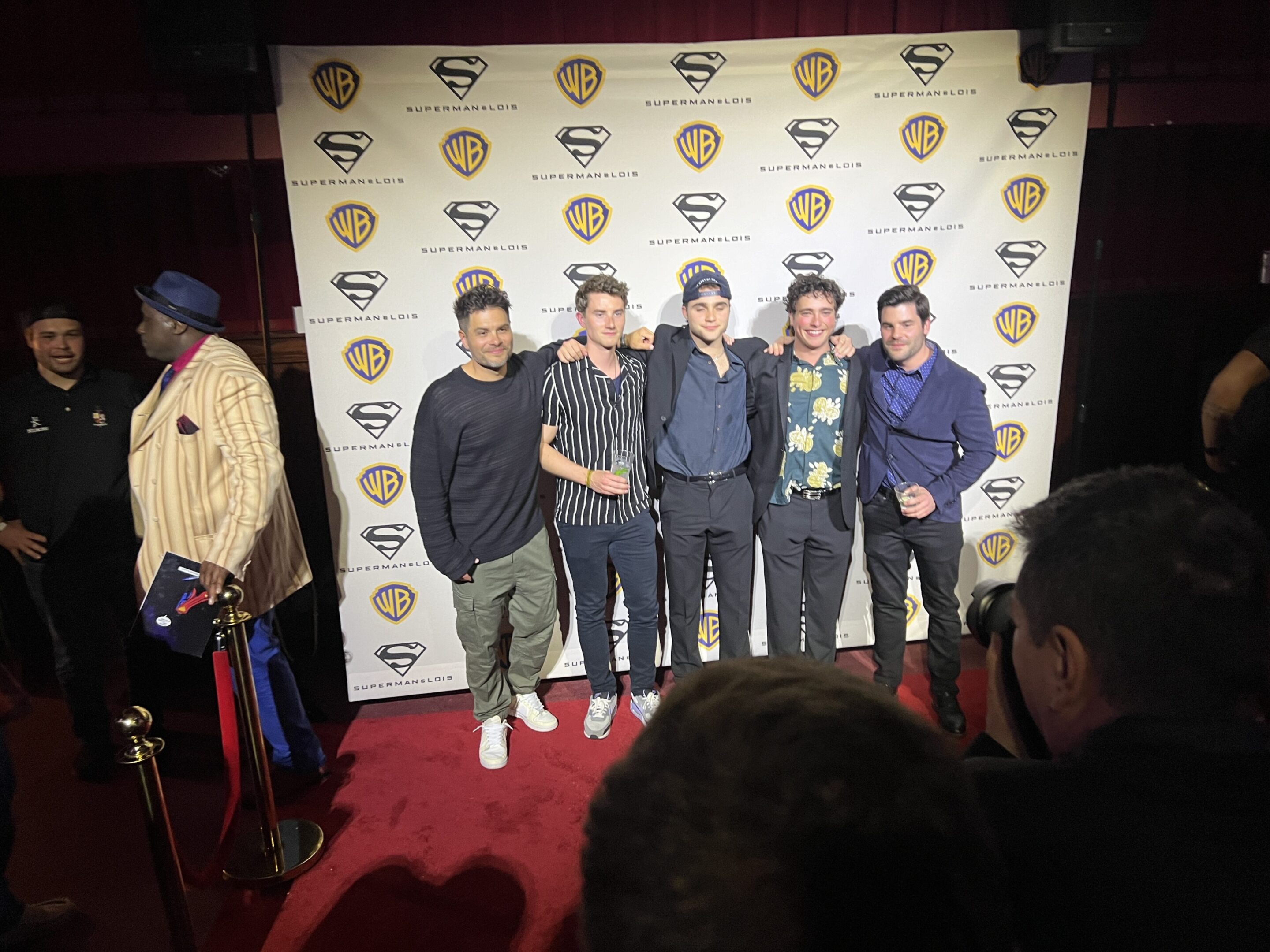 A group of people standing on the red carpet