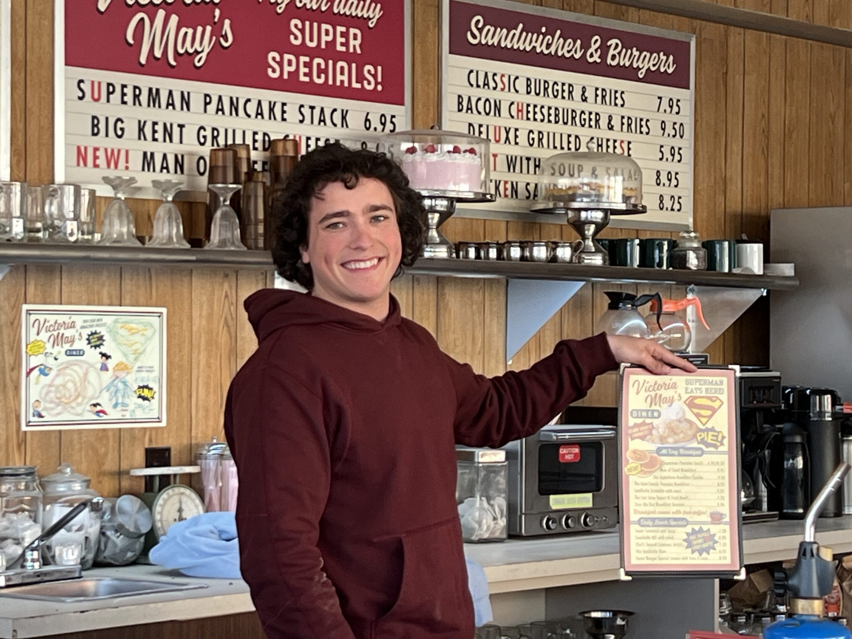 A man in a red shirt is behind the counter