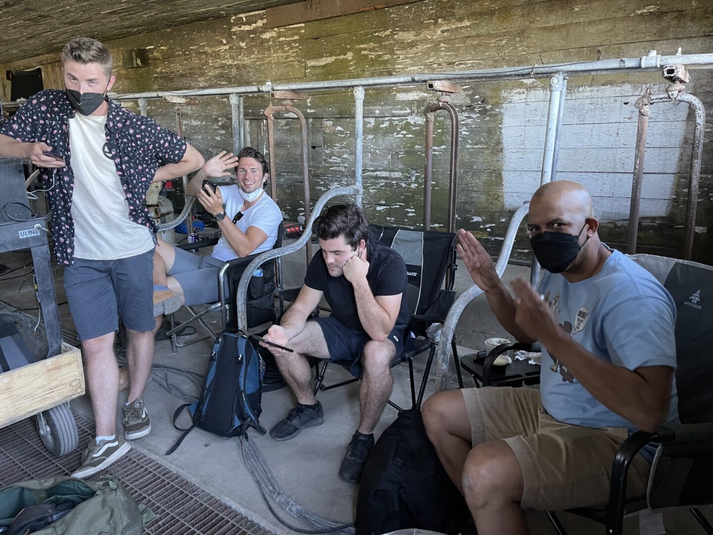 A group of people sitting on chairs next to each other.