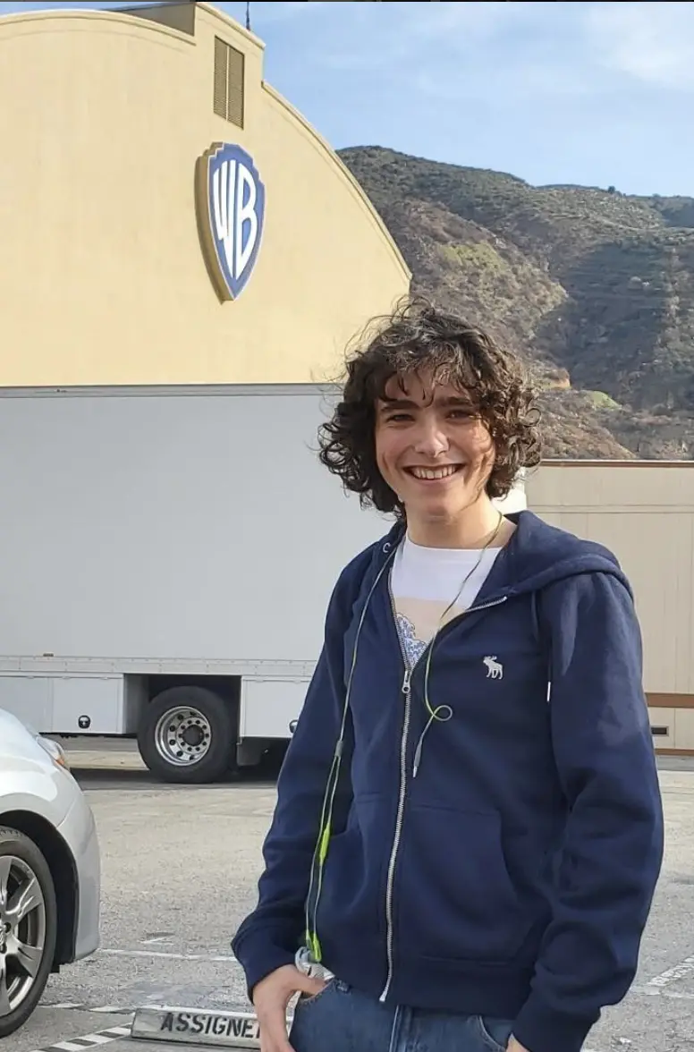 A woman standing in front of a white truck.