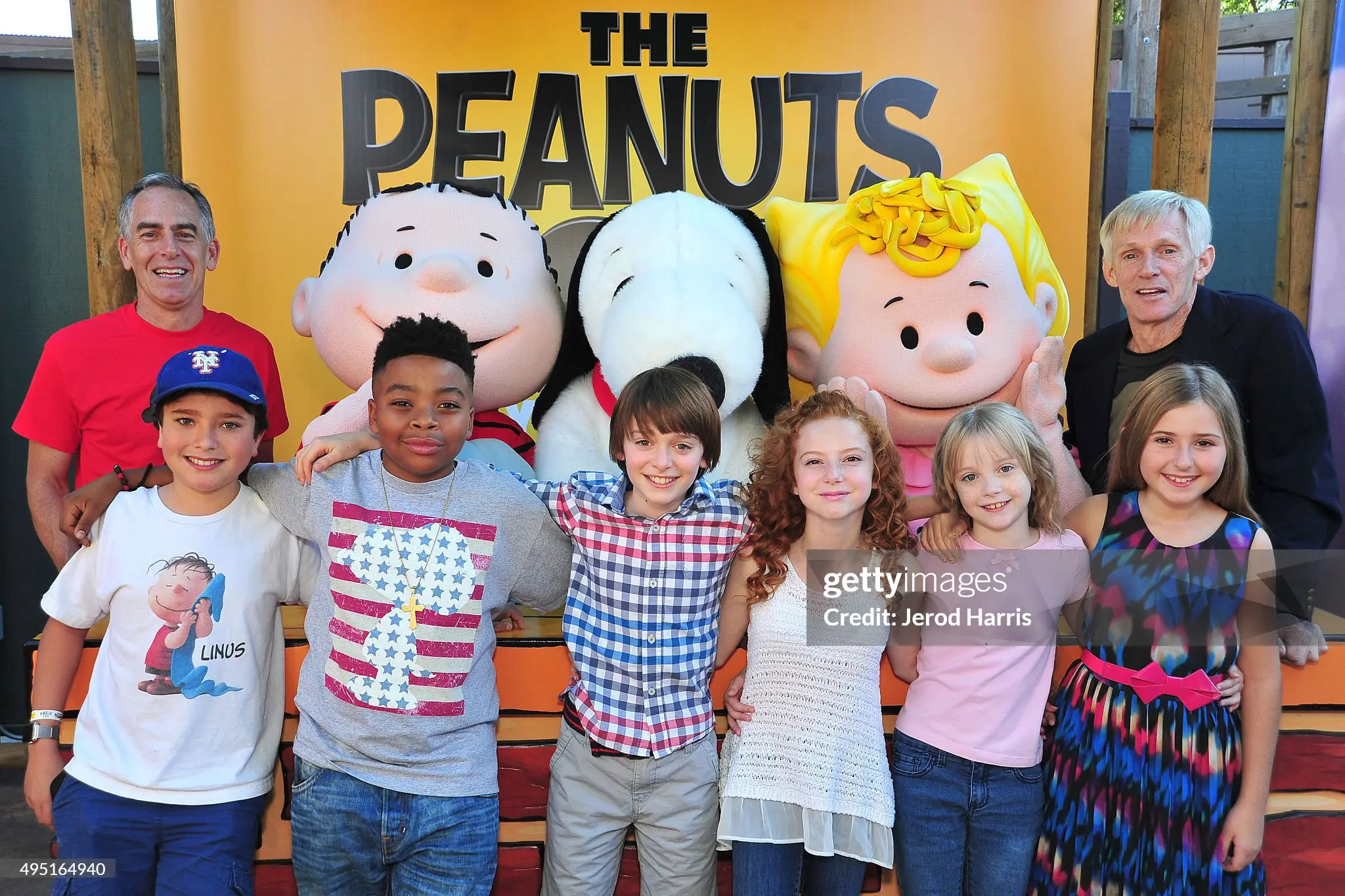 A group of children posing for the camera with peanuts characters.